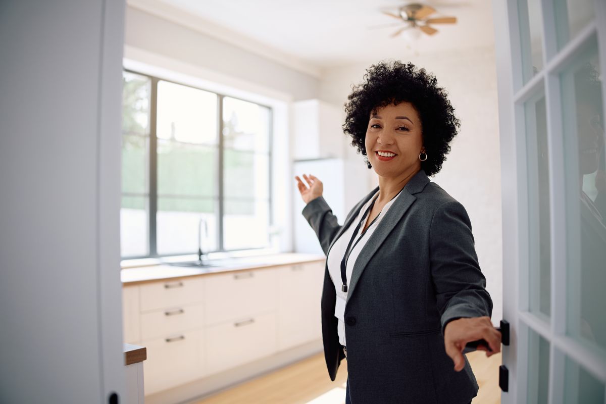 Property owner welcoming guests at their accommodation